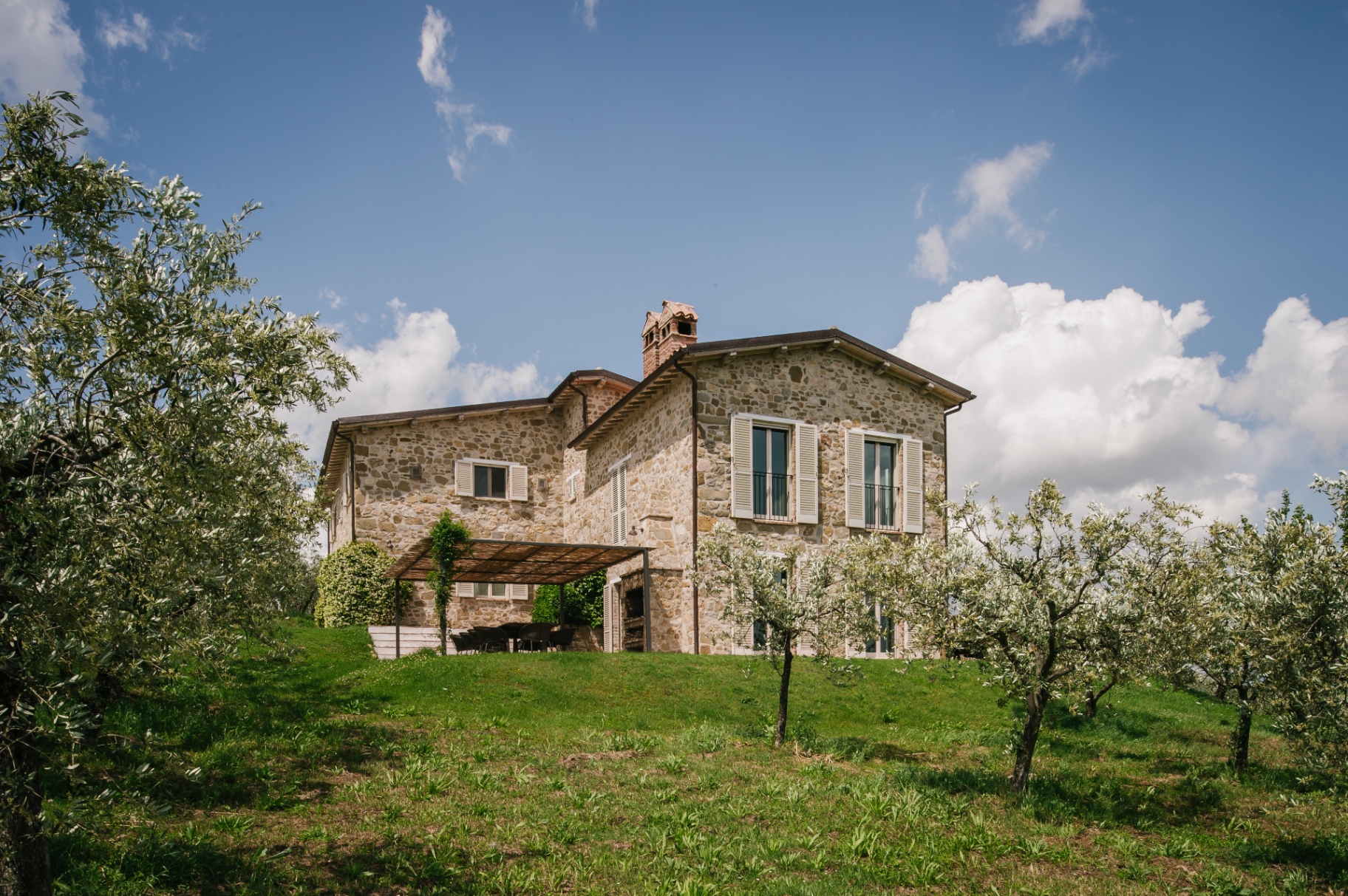Casa Winther stone villa exterior surrounded by olive trees in the Umbrian countryside